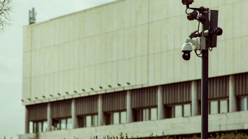 Multi-camera surveillance pole standing on a city street