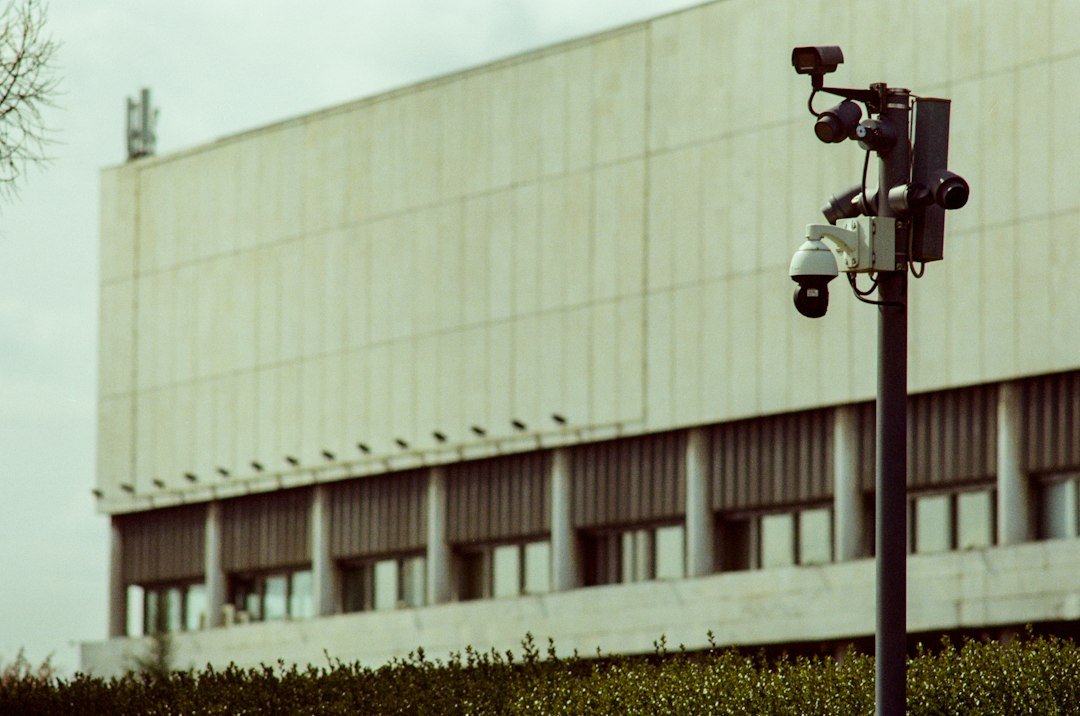 Multi-camera surveillance pole standing on a city street