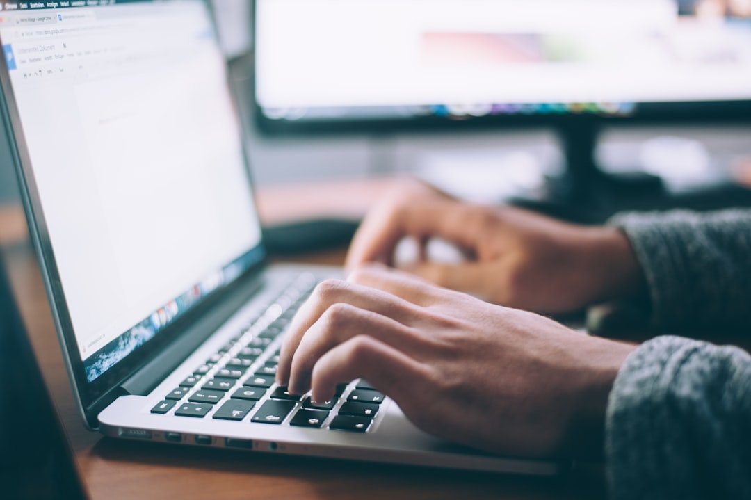 Person typing on a laptop keyboard while researching search results