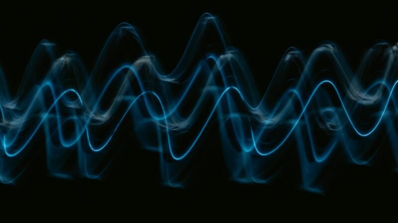 Abstract blue sound wave on black background, representing voice detection technology