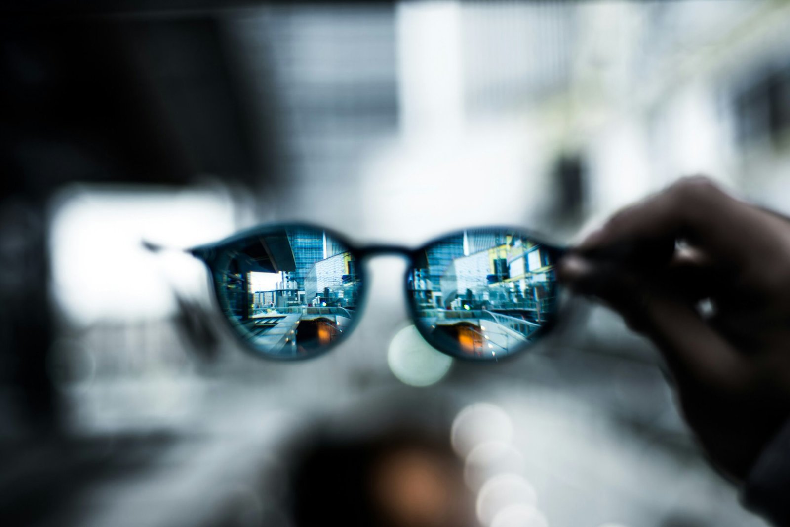 Person wearing smart glasses outdoors, illustrating hands-on AR wearable use