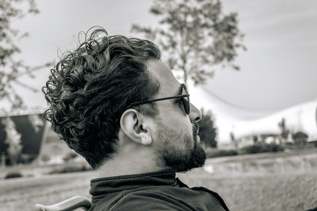Man wearing sunglasses style smart eyewear outdoors in natural light