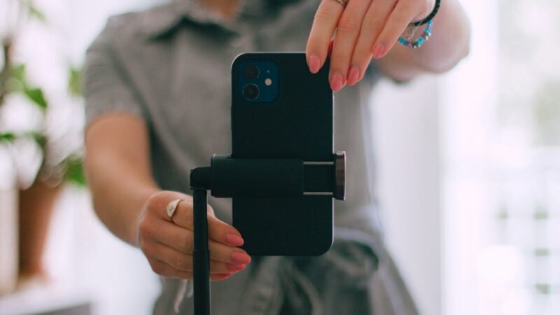 Woman taking a picture with her cell phone outdoors