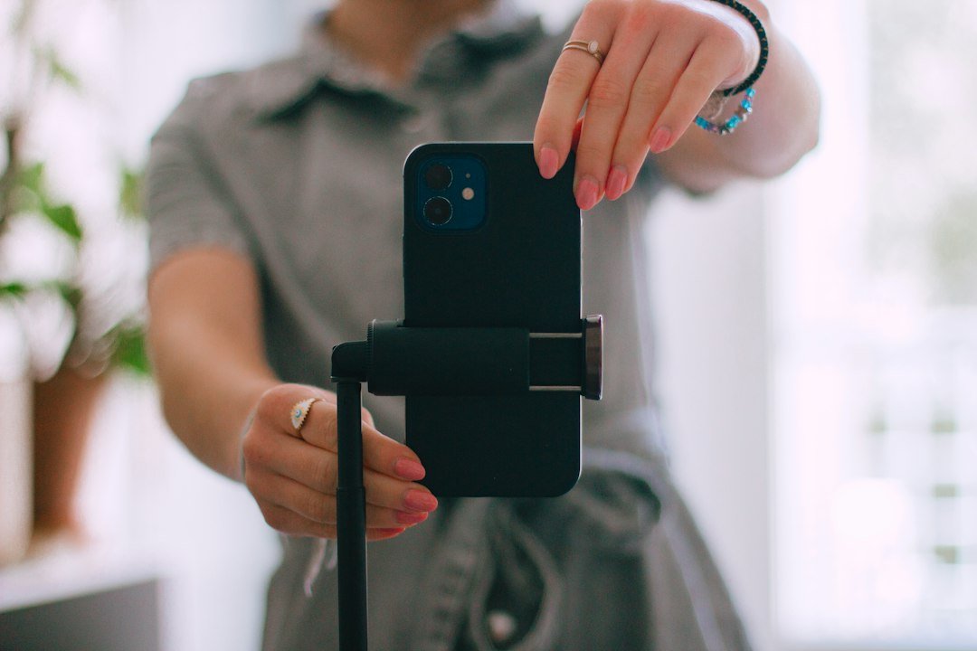Woman taking a picture with her cell phone outdoors