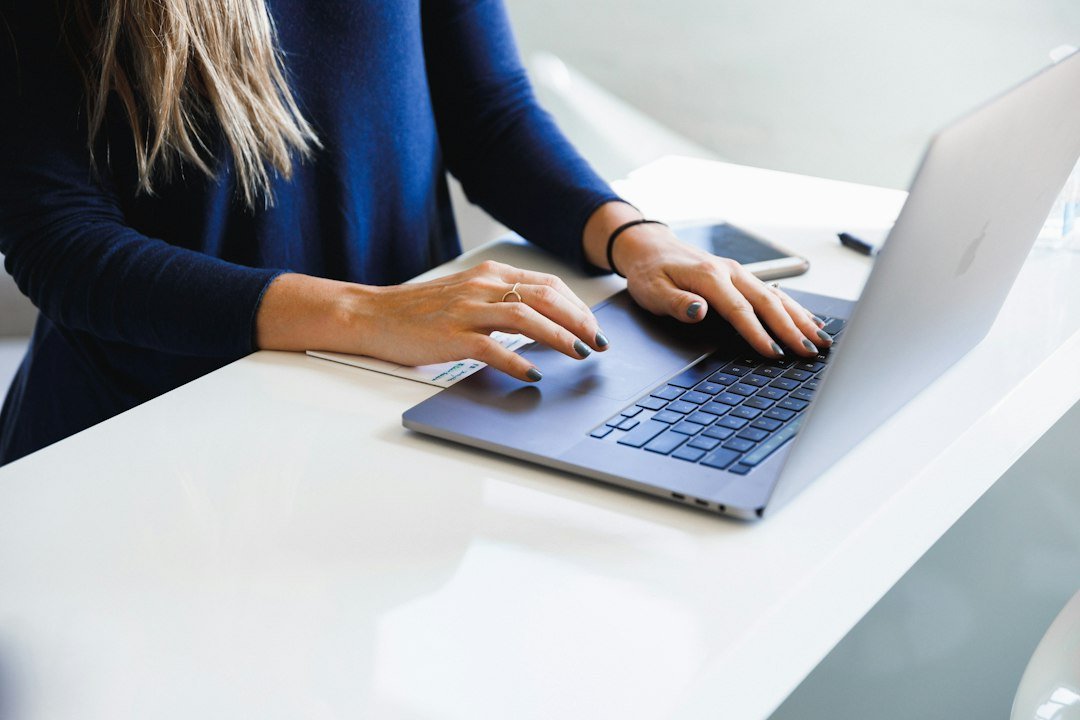 Person typing and editing a document on a laptop, representing AI paraphrasing and writing tools