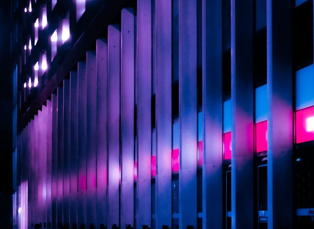 Illuminated building facade at night representing the fast-moving AI decision-model software race between OpenAI and TypeSafe
