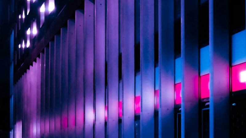Illuminated building facade at night representing the fast-moving AI decision-model software race between OpenAI and TypeSafe