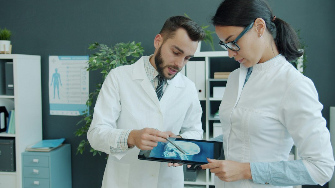 Doctors reviewing an x-ray on a tablet, representing AI-assisted medical diagnosis