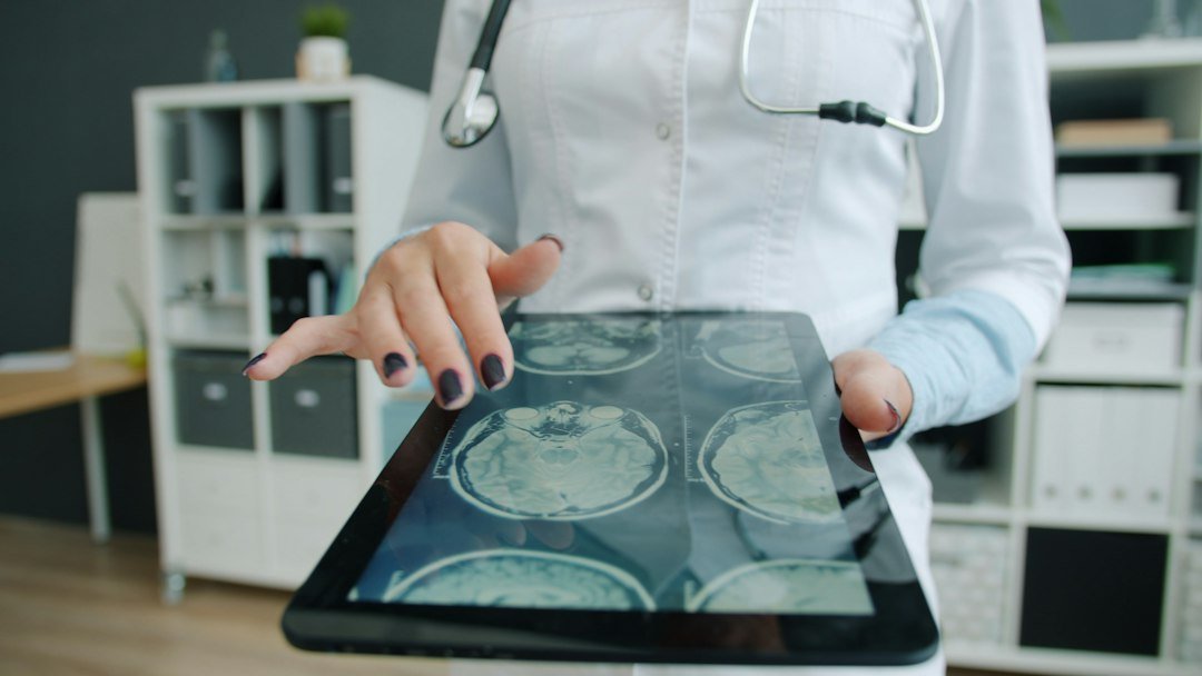 Doctor reviewing MRI scan results on a tablet, representing AI-assisted medical diagnosis