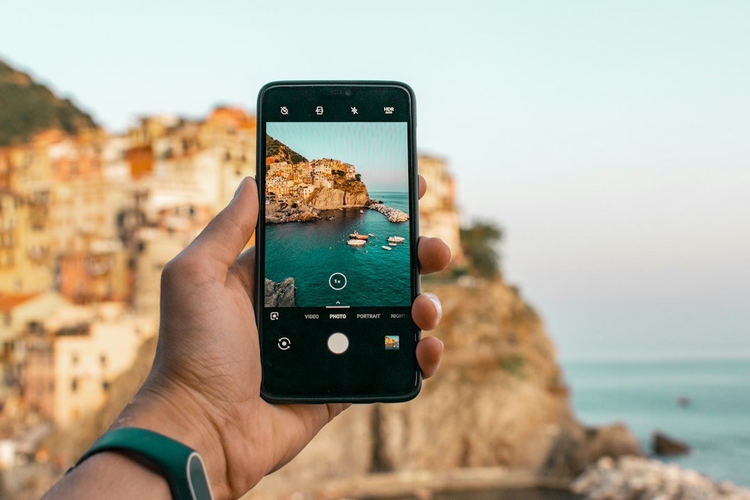 Person using a translation app on a phone while traveling, representing the best AI translator tools