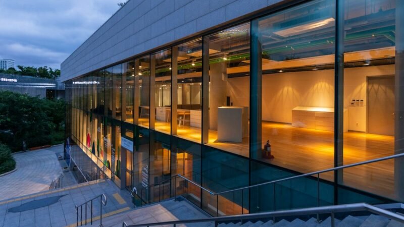 Modern corporate office building exterior at dusk with glass facade