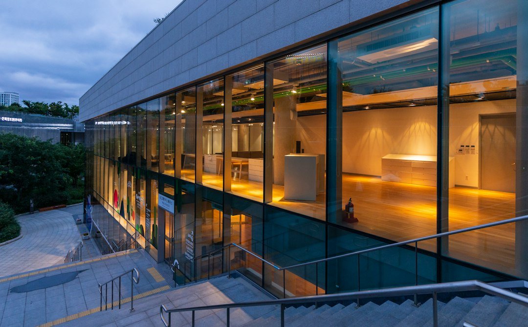 Modern corporate office building exterior at dusk with glass facade