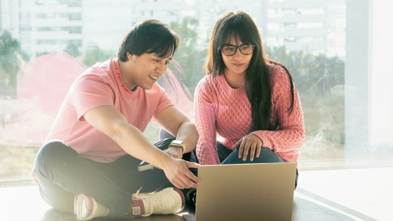 Couple working together on a side hustle at home