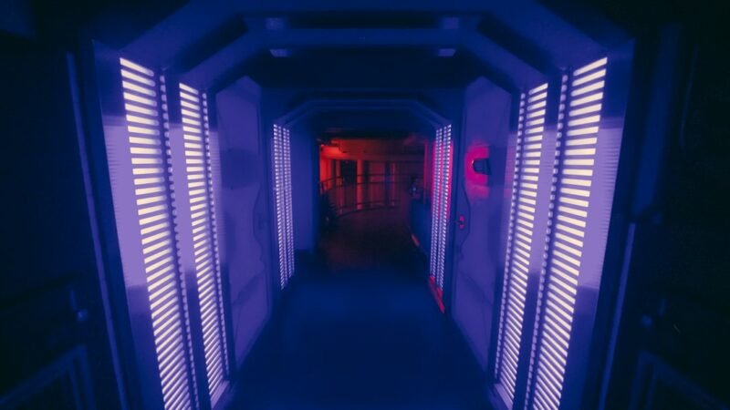 Long corridor with shutters and red light representing data center infrastructure risk
