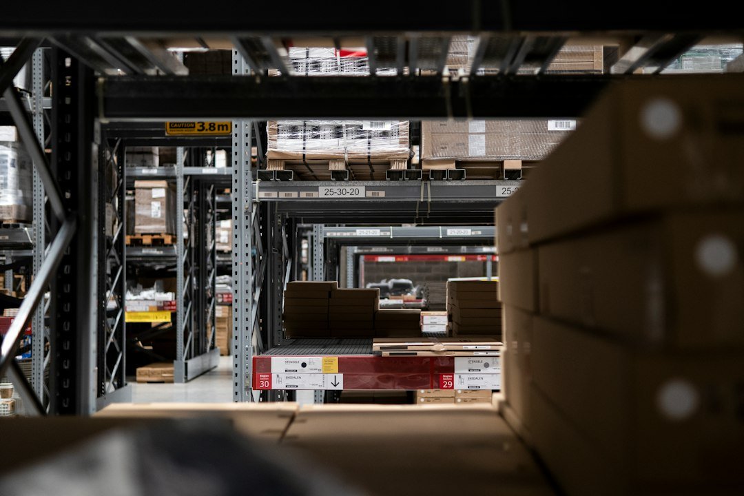 Warehouse filled with stacked shipping boxes, representing e-commerce fulfillment and AI shopping agents