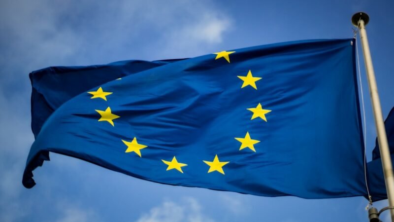 The European Union flag flying in front of the EU Parliament in Brussels