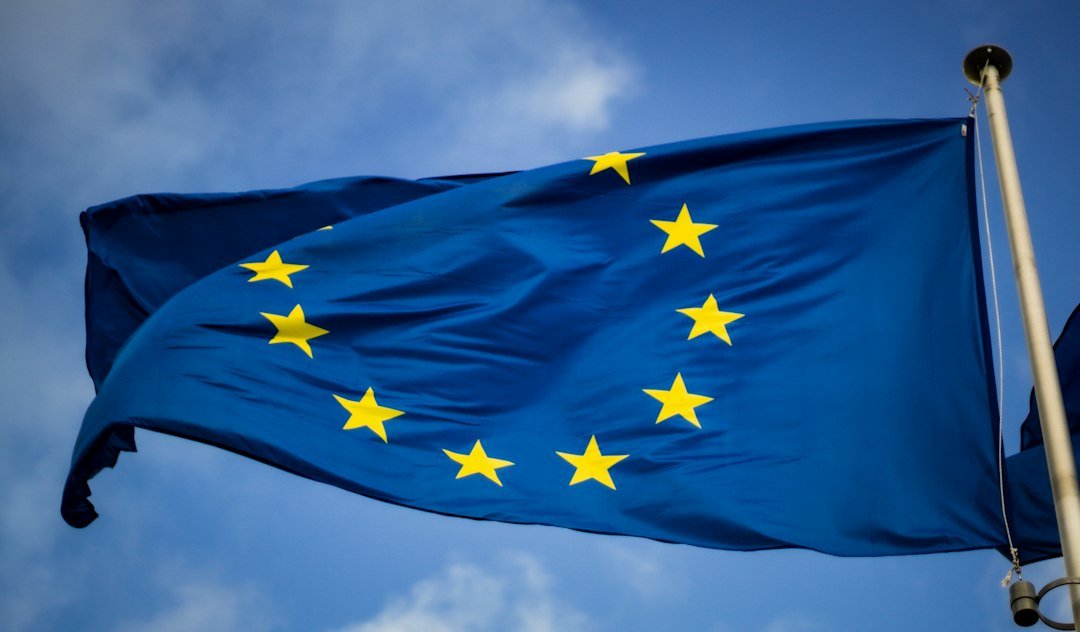 The European Union flag flying in front of the EU Parliament in Brussels
