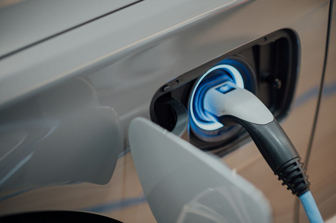 A close-up of an electric vehicle charger connector plugged into a car