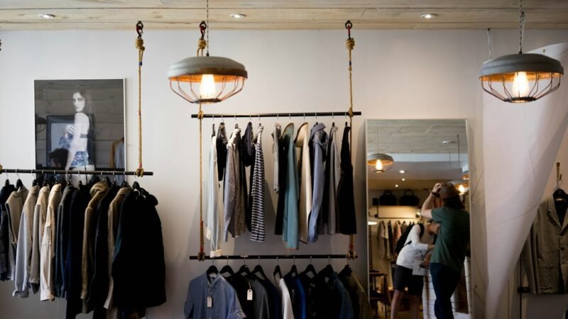 Clothing organized on racks inside a fashion retail store