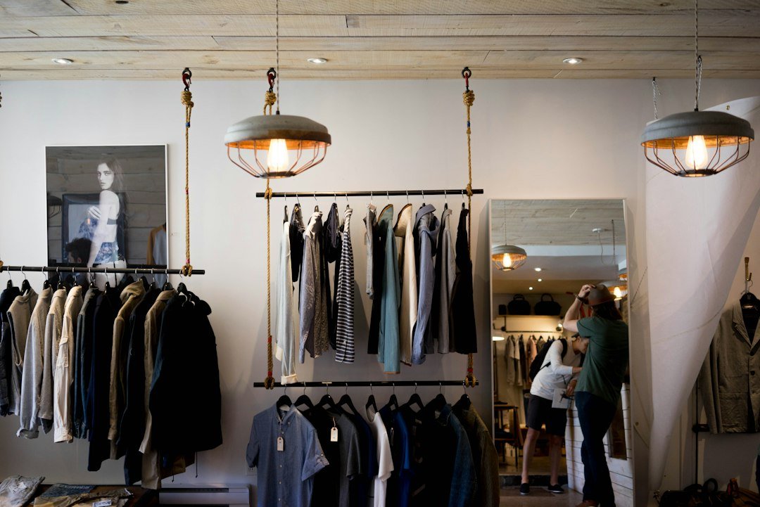 Clothing organized on racks inside a fashion retail store