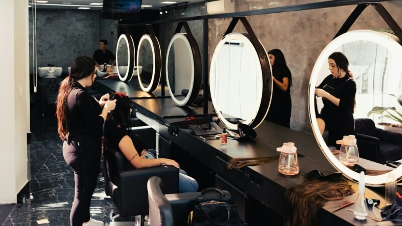 Hairstylist cutting a client's hair in a salon, showing why people preview haircuts with an AI hairstyle generator first