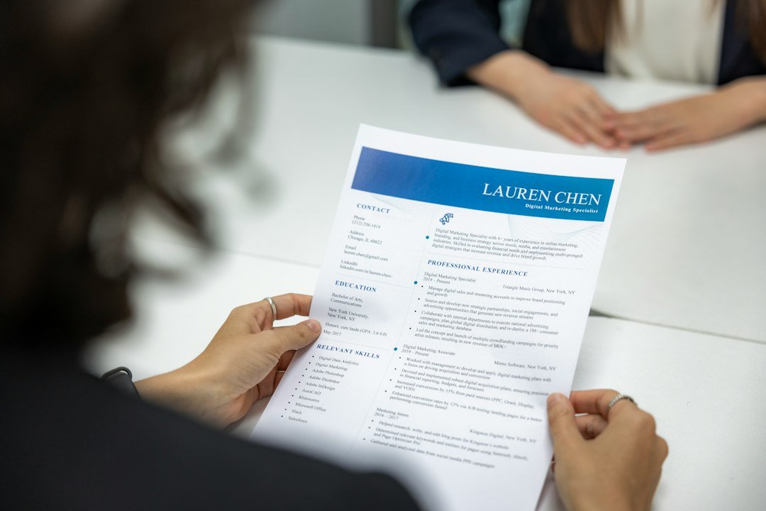Job seeker reviewing a printed resume at a desk, representing free AI resume builders