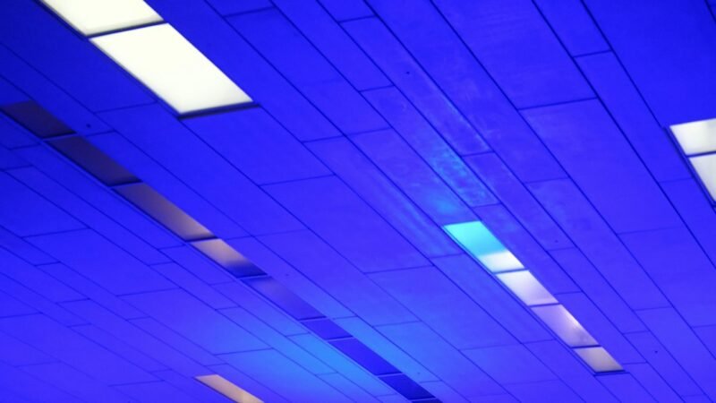 Blue illuminated ceiling panels inside a data center representing AI infrastructure