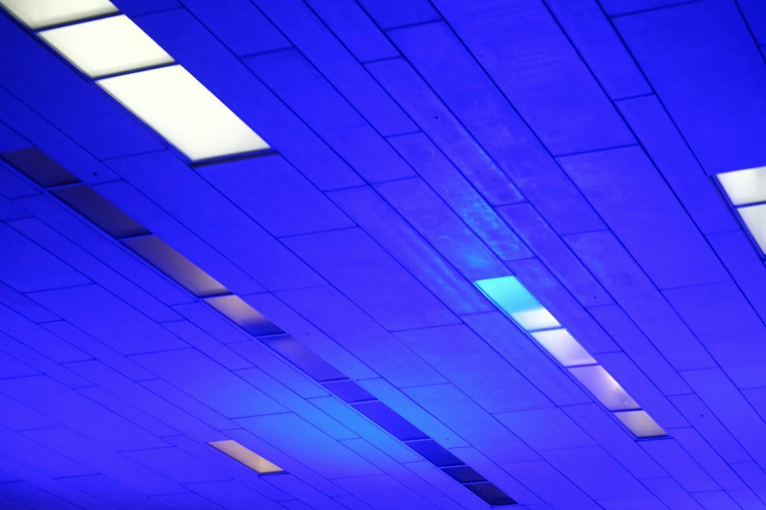 Blue illuminated ceiling panels inside a data center representing AI infrastructure