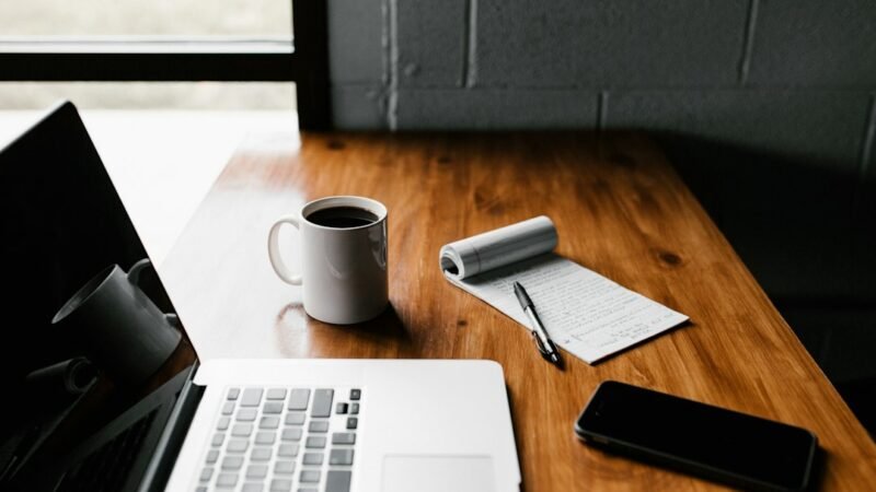 Laptop on an office desk representing productivity software and AI assistants