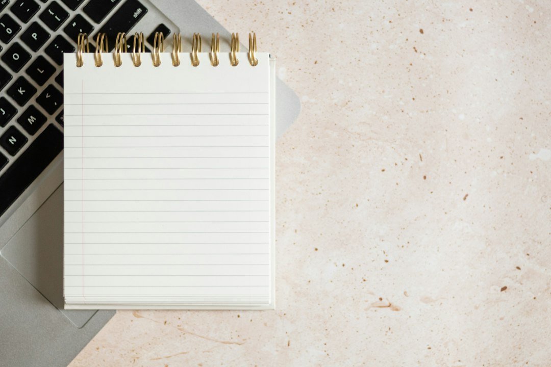 Laptop with notebook flat lay, a simple setup for starting an online side hustle
