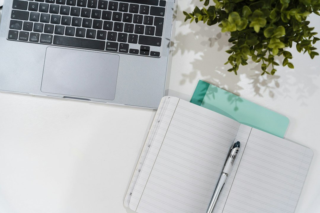Laptop and journal on a desk, representing online side hustles you can start from home