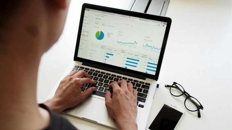 Person working on a laptop reviewing data