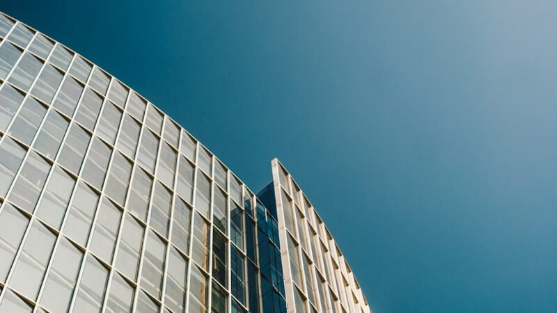 Exterior view of a modern corporate office tower, representing Qualcomm's global workforce reduction