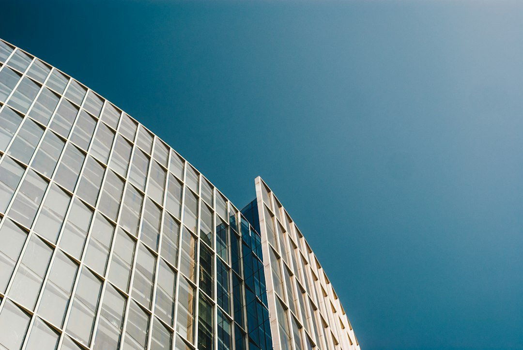 Exterior view of a modern corporate office tower, representing Qualcomm's global workforce reduction