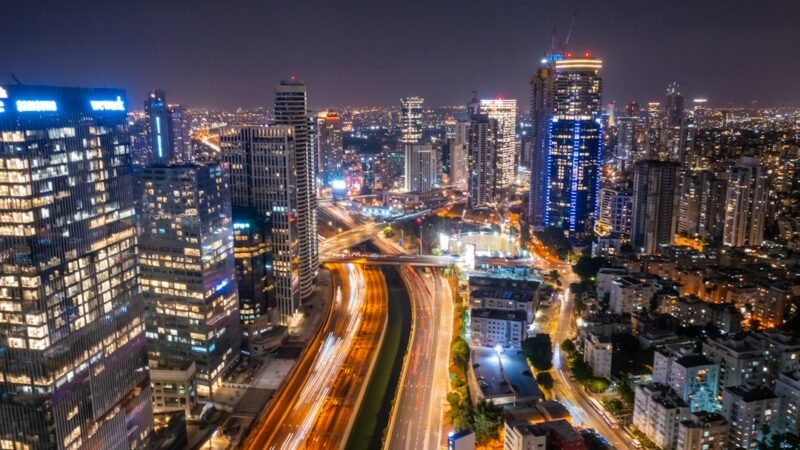 City financial district skyline at night representing fintech growth