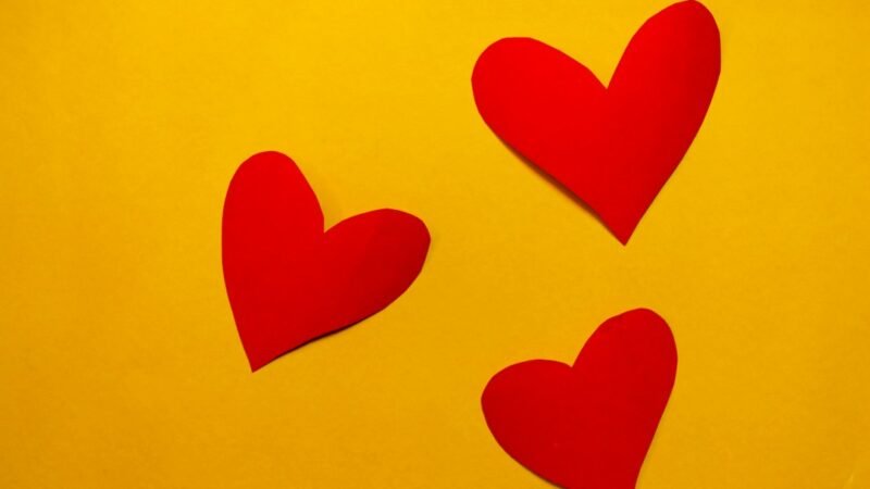 Red hearts on a yellow background, illustrating the red heart meaning on Snapchat