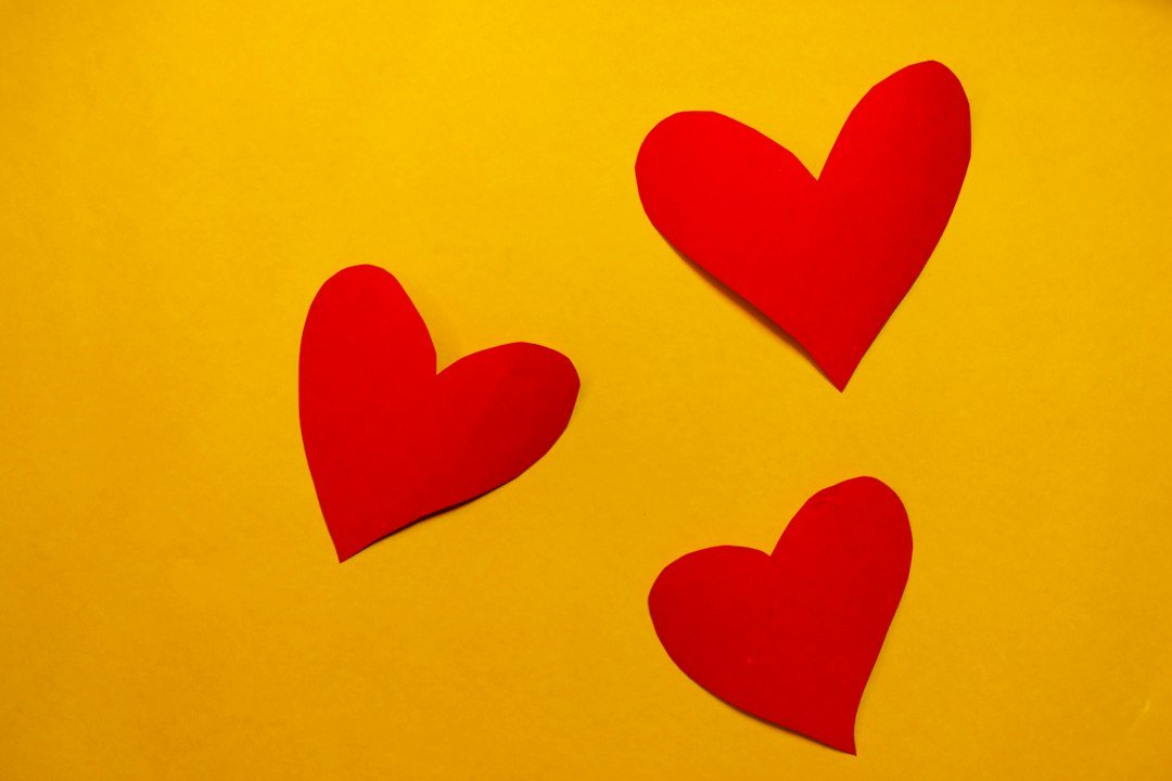 Red hearts on a yellow background, illustrating the red heart meaning on Snapchat