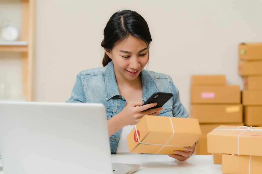 Small business owner packing ecommerce orders at a home workspace