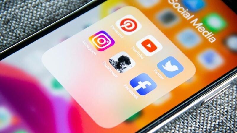 A smartphone screen showing various social media app icons including Facebook