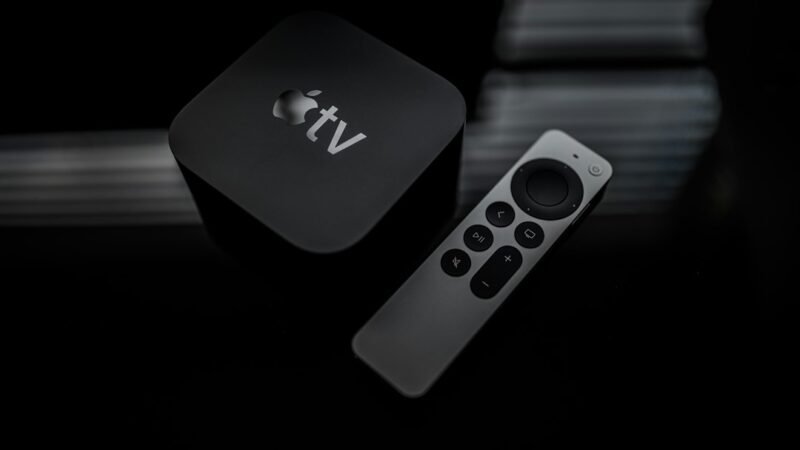 Person holding a streaming TV remote in front of a television