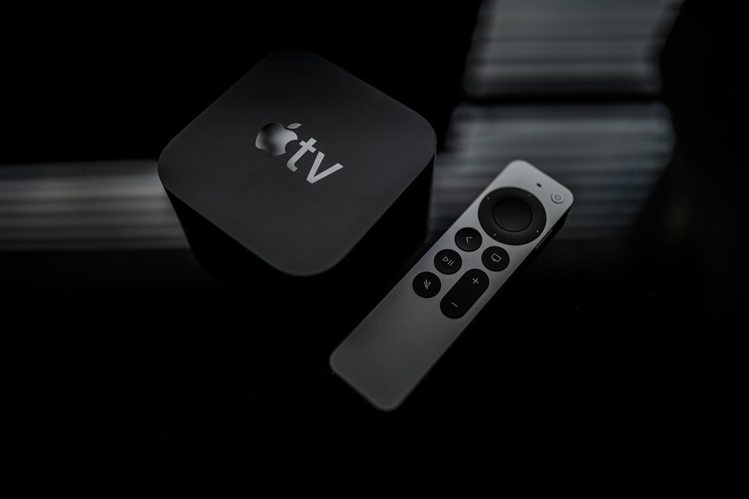 Person holding a streaming TV remote in front of a television