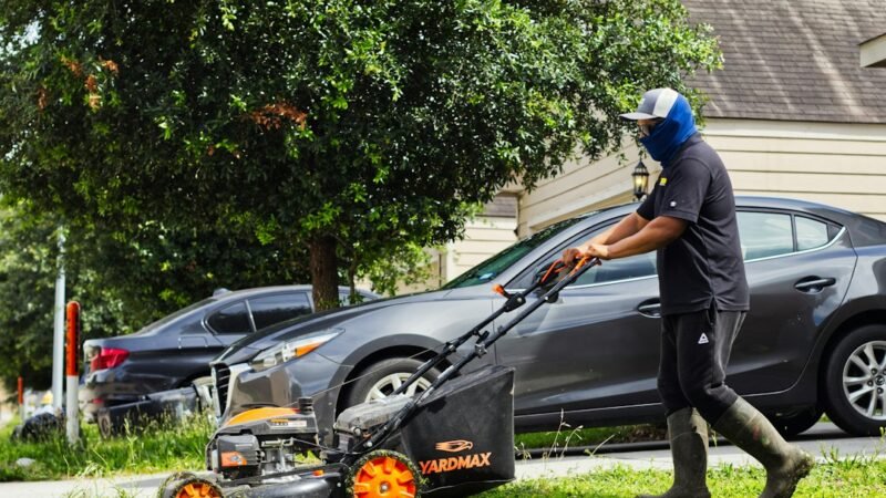 Teenager mowing a neighbor's lawn as a summer side hustle