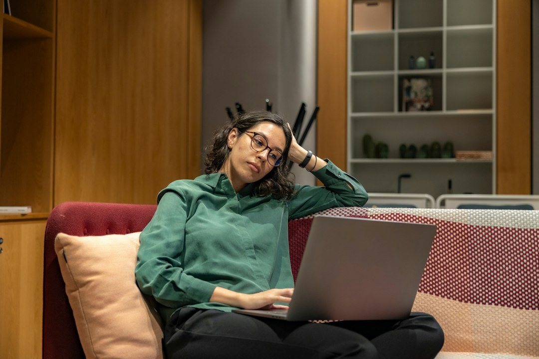 Woman working on a laptop in a relaxed office as part of a virtual assistant side hustle