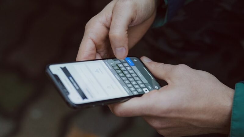 Person typing an emphatic message on a phone, illustrating what ISTG means in text