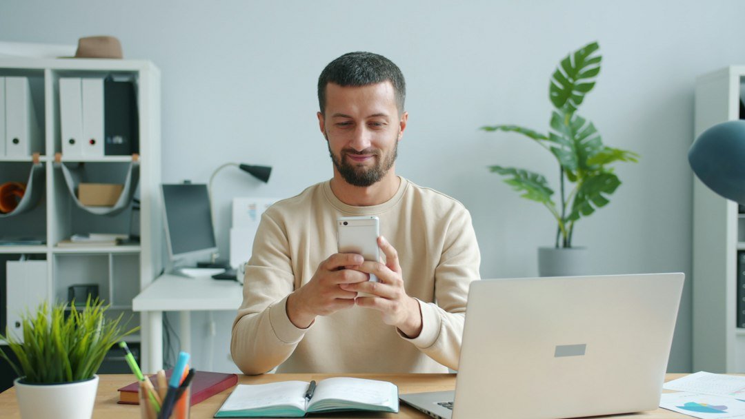Worker using workplace chat app on smartphone