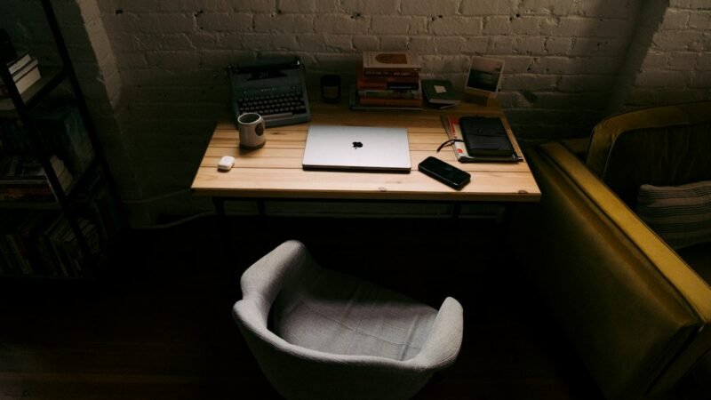 Laptop on a wooden desk representing a workplace affected by new AI employment law