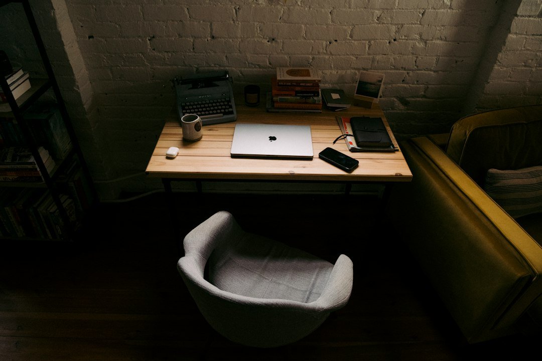 Laptop on a wooden desk representing a workplace affected by new AI employment law