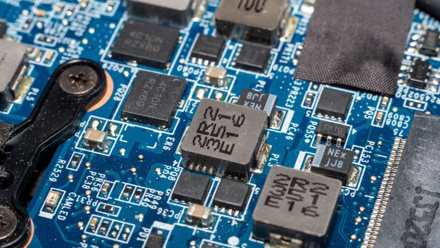 Close-up of a blue electronic circuit board with chips and components