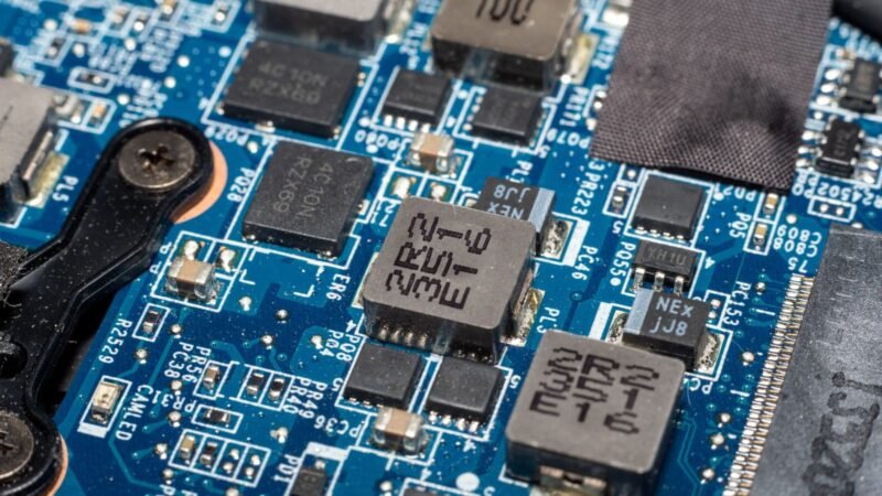 Close-up of a blue electronic circuit board with chips and components