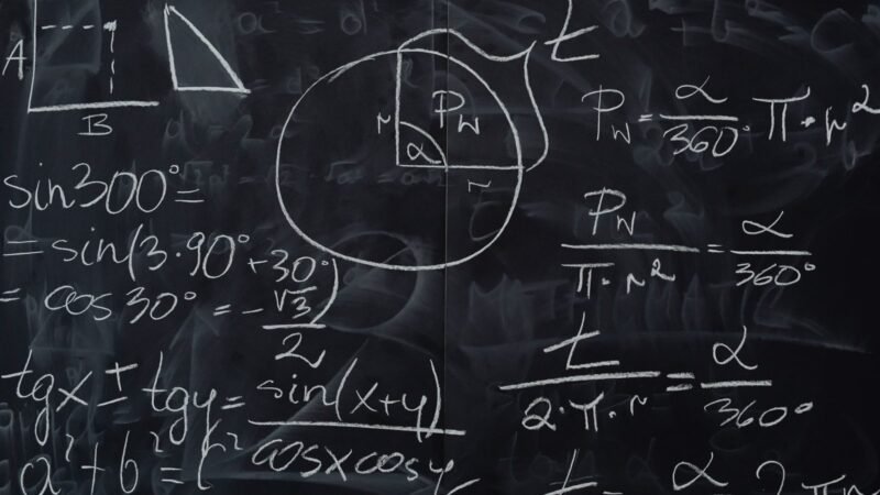 Mathematical equations and geometric diagrams drawn on a chalkboard